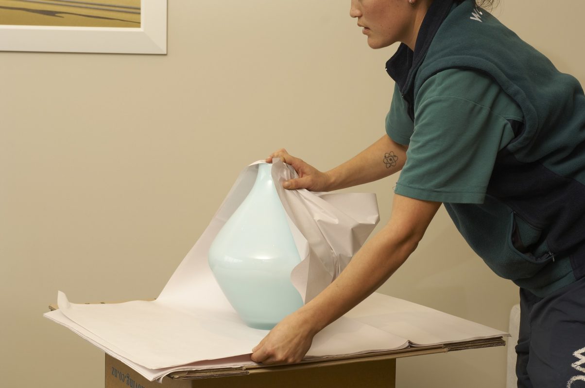 woman wrapping a vase